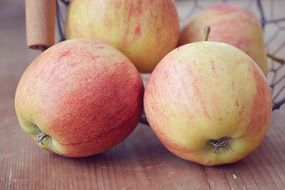 four natural apples on the table