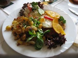 Delicious meal with meat, potatoes and vegetables on plate