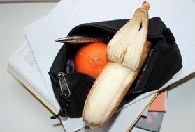 tangerine and banana in a purse