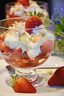 dessert with strawberries in a transparent bowl