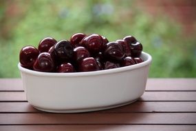 ripe Cherries in white bowl outdoor