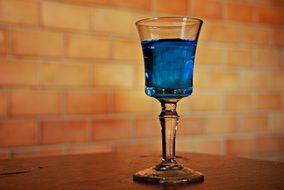 A glass of the blue alcohol drink with ice