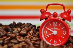 red Alarm Clock on coffee beans