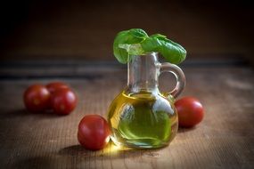 a bottle of olive oil next to the tomatoes