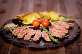 medium fried meat with a garnish in a restaurant