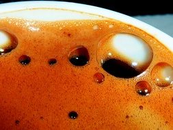 closeup photo of orange coffee foam