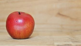 red apple on wooden board