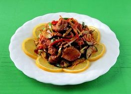 tasty Pork with vegetables and lemon slices
