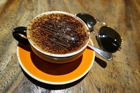 Cup Of Coffee and sunglasses on table