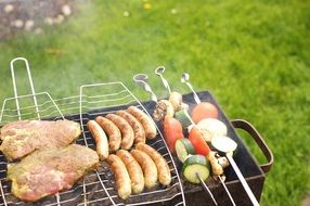 barbecue with sausages and meat in nature