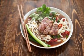 asian food with noodles on a white plate