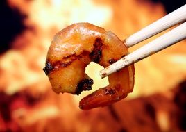 keep fried shrimp with chopsticks