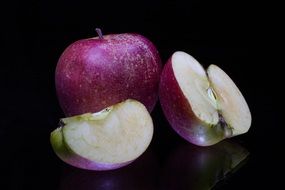 purple apples on a black background