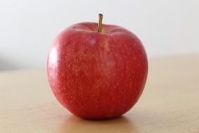 red sweet Apple on table closeup