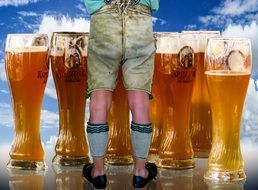 glasses of beer and men's legs in stockings and shoes, oktoberfest