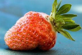 ripe strawberries on a blue table