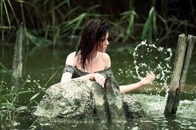 young woman splashing around in water