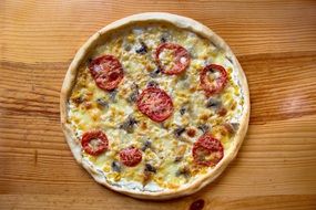 Pizza with Tomatoes on wooden table