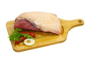 chicken thigh and chili pepper on a wooden board
