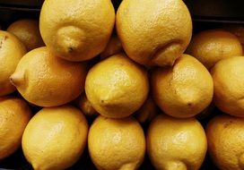 lemons stacked on top of each other in the market