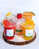 Fresh Holly food's smoothies in cups with fruits at top