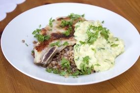 pork steak with sauce in a white plate on the table