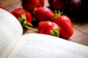 red strawberries and open recipe book