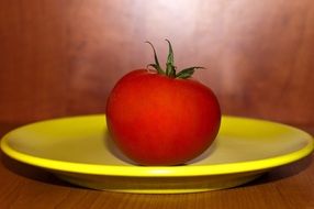 tomato on a yellow plate