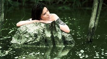 brunette Girl in water on stone