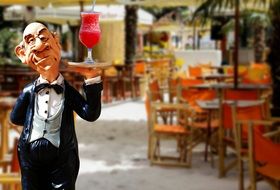 ceramic figure of a waiter with a cocktail