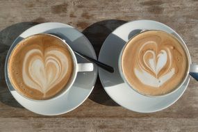 two white cups with cappuccino