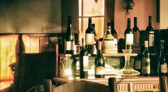 Wines in bottles on stand in restaurant