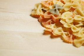 raw colorful Pasta on wooden Board