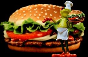 ceramic frog in chef's hat with burger