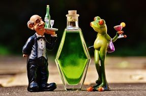 ceramic figure of a toad with a balcony and a waiter with a tray of bottles