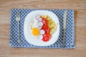 fried eggs with vegetables for breakfast