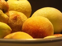 yellow fresh Peaches in bowl close-up