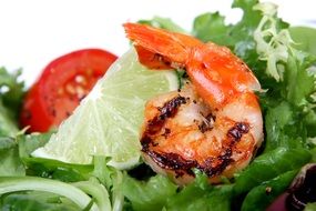 Asian Barbecue prawn with lime and salad close-up