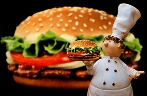 cheeseburger and ceramic chef figurine