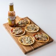 pizza with sauce on a wooden board