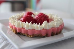 delicious cake with air cream and raspberries