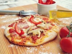 Pizza with cheese , tomatoes and mushrooms