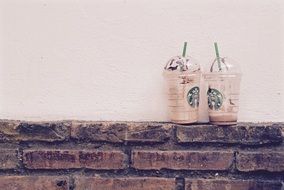 cardboard cups with coffee of company of a starbucks