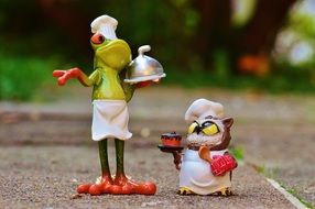 frog and owl figures as cooks