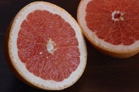 Grapefruit half on a dark background close-up