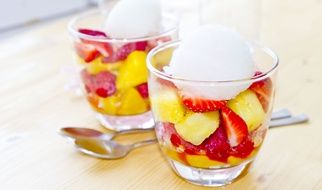 Peaches,strawberries and ice cream in the glasses
