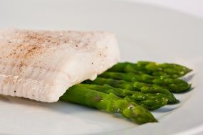 fish with asparagus on a plate