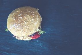 tasty hamburger on blue background