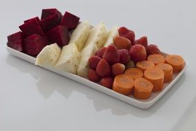 slices of fruits and vegetables on a plate