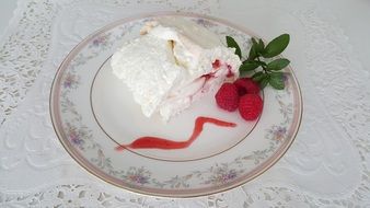 ice cream with mint leaves and raspberries